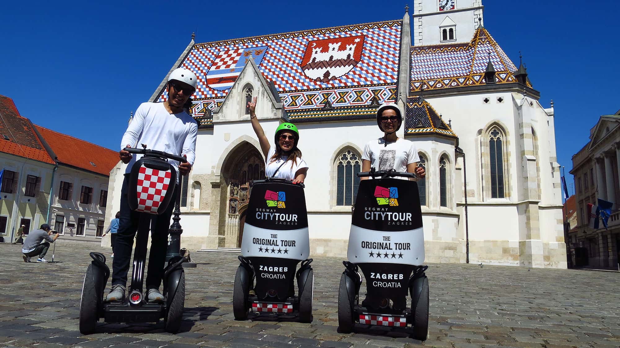 Visit Zagreb - Segway City Tour Zagreb - three people on segwaya at St. Mark's Square